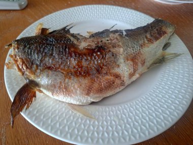 Beyaz tabakta ızgara uskumru.