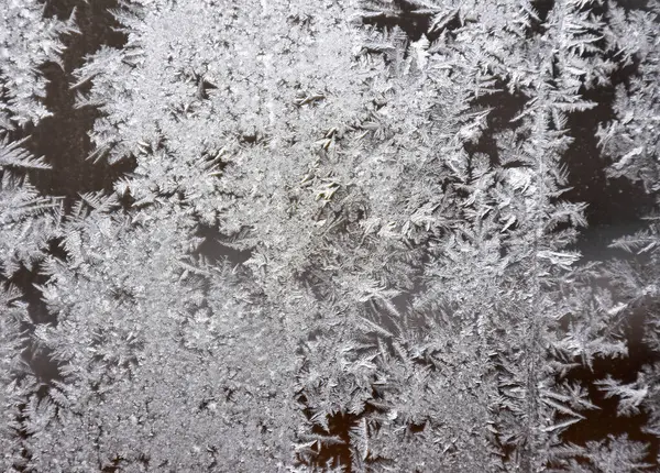 stock image Frost on the window, natural pattern. Frozen particles on a window glass. Different ice crystals texture background. High quality photo