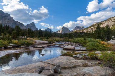 The East Fork River in the Wind River Range of Wyoming. Left to right, Ambush Peak, Raid Peak and Midsummer Dome are seen to the north. clipart