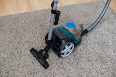 Vacuum cleaner brush on a gray rug