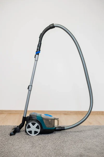 Vacuum cleaner brush on a gray rug