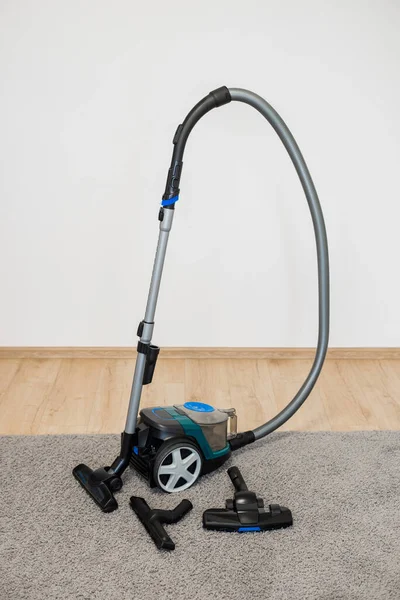 Vacuum cleaner brush on a gray rug