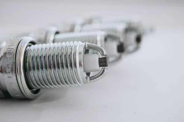 stock image Car service. A set of new car spark plugs as a spare part of motor vehicles on white. Group of candles for the motor close-up