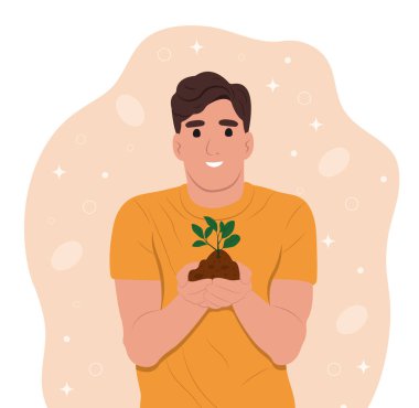 Dünya Toprak Günü her yıl 5 Aralık 'ta düzenlenir. Adam elinde yeşil bir bitki tutuyor.