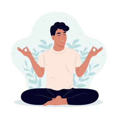 Uluslararası Yoga Günü. Genç adam meditasyon yaparken gözleri kapalı, bacakları dışarıda çaprazlanmış.