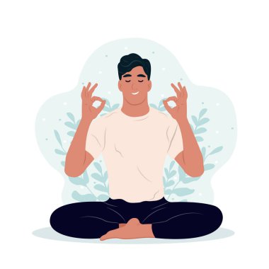 Uluslararası Yoga Günü. Genç adam meditasyon yaparken gözleri kapalı, bacakları dışarıda çaprazlanmış..