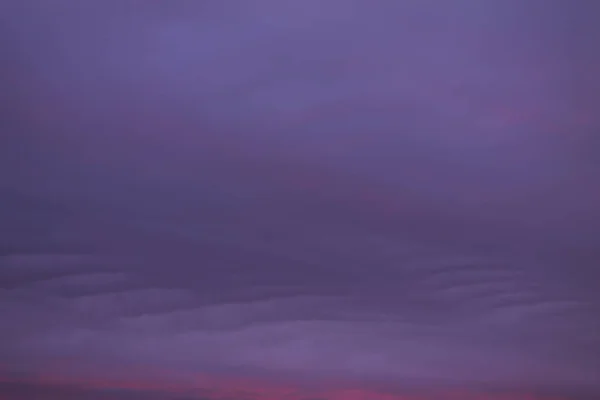 purple sunset on the sky with the clouds background