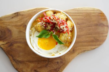 Et ve yumurtalı bir kase yemek. Kase beyaz bir yüzeye yerleştirildi.