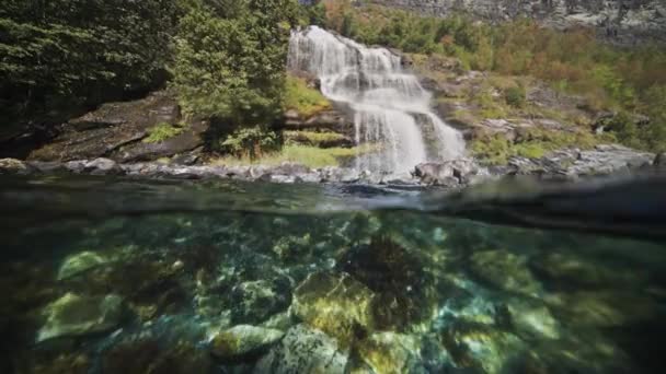 Shot Fjord Sun Flares Dance Rocky Bottom Waterfall Cascades Shore — Stock Video