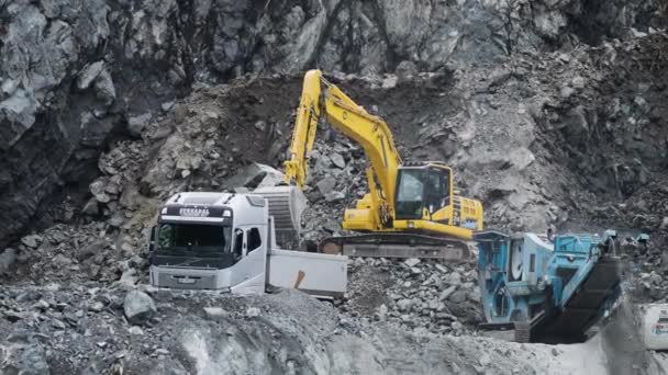Excavator Loads Tuck Stones Quarry Slow Motion Pan Right High — Stock Video