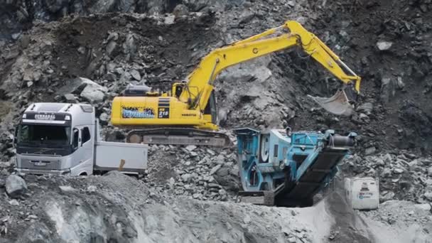 Excavator Loads Tuck Stones Quarry Slow Motion Pan Right High — Stock Video