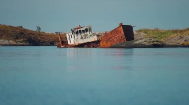 An old rusty shipwreck on the shore along the Atlantic road. High-quality 4k footage