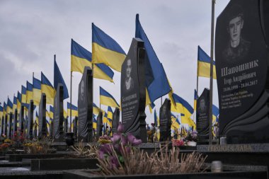 Kharkiv, Kharkiv Oblast, Ukraine. February 18, 2023 City Cemetery. Graves of Ukrainian soldiers in the Alley of Glory.