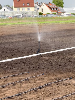 artificial irrigation on fields in germany. Shows an irrigation system. Nuremberg, Germany. clipart