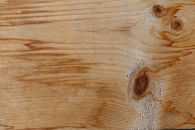 Tahta taneciklere yakın çekim, düğümler ve kahverengi tonlarda çeşitlilik. Yatay bileşim, doğal doku ve detaylar.