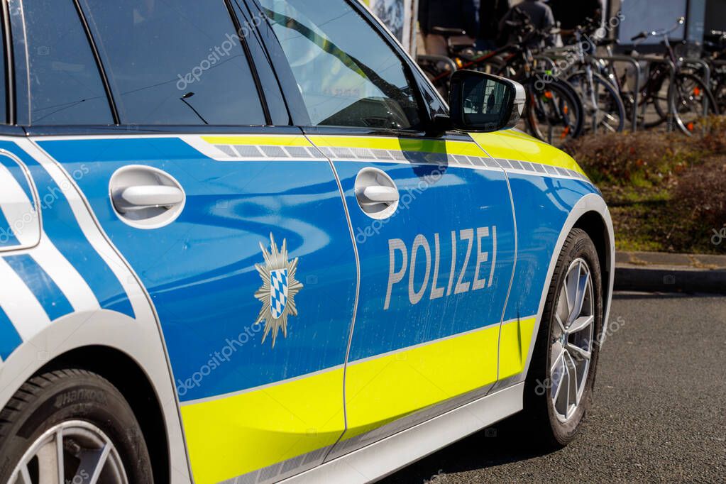 Nuremberg, Germany, 2025 March 02: Close-up of a German police car featuring blue, yellow, and white stripes, the word 