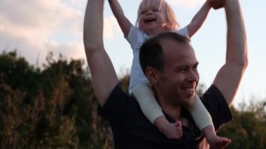 Portrait of a cheerful father carrying his son around his neck. High quality 4k footage