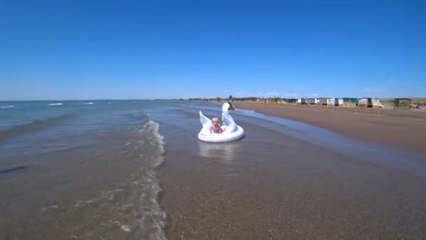 Little Boy Rides Inflatable Swan Sea High Quality Footage — Vídeo de Stock