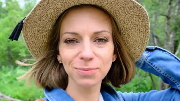 Una Donna Con Cappello Guarda Telecamera Mezzo Alla Foresta Filmati — Video Stock