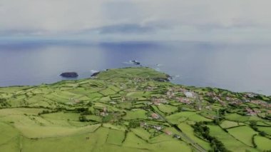 Flores Adası 'nın güneşli bir günde, Azores, Portekiz, Avrupa' daki hava manzarası. Atlantik Okyanusu 'ndaki yeşil tarlaları çevreleyen evlerin panoramik görüntüsü, 4k görüntü.