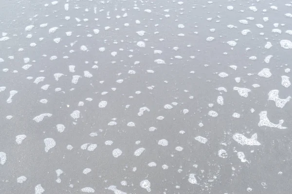 Wazig Foto Van Grijs Donker Zand Strand Oppervlak Met Kleine — Stockfoto