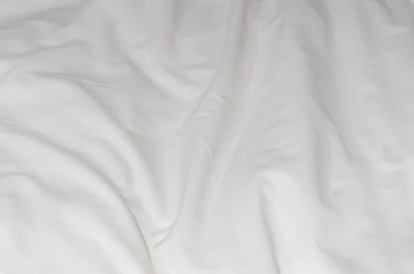 stock image White crumpled or wrinkled bedding sheet or blanket with pattern after guest's use was taken in hotel, resort room with copy space. Untidy blanket background texture
