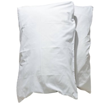 Two white pillows with cases after guest's use at hotel or resort room is isolated on white background with clipping path. Concept of confortable and happy sleep in daily life