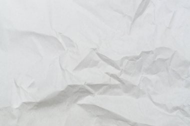 Wrinkled or crumpled white stencil paper or tissue after use in toilet or restroom with large copy space is used for background texture in art work.