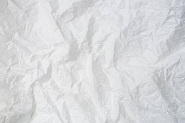 Wrinkled or crumpled white stencil paper or tissue after use in toilet or restroom with large copy space is used for background texture in decorative art work.