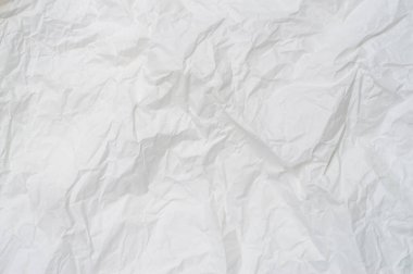 Wrinkled or crumpled white stencil paper or tissue after use in toilet or restroom with large copy space is used for background texture in decorative art work.