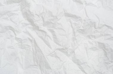Wrinkled or crumpled white stencil paper or tissue after use in toilet or restroom with large copy space is used for background texture in art work.