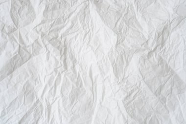Wrinkled or crumpled white stencil paper or tissue after use in toilet or restroom with large copy space is used for background texture in decorative art work.