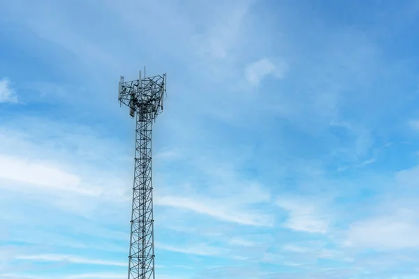 Internet signal tower or mobile phone signal tower is isolated on blue sky background texture. Global communication and internet network connection concept