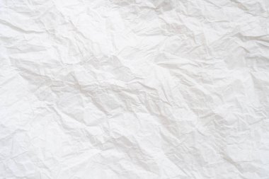 Wrinkled or crumpled white stencil or tissue paper is used for crumpled paper background texture.	