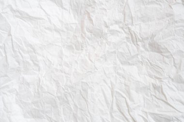 Wrinkled or crumpled white stencil or tissue paper is used for crumpled paper background texture.	