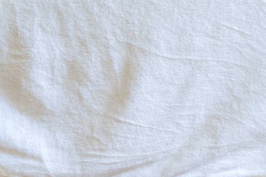 Wrinkled or crumpled white towel texture or background was taken with soft natural light used for clothing background or texture. clipart