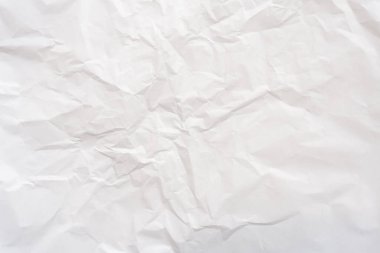 Wrinkled or crumpled white stencil or tissue paper is used for crumpled paper background texture.	