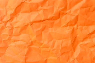 Üst görünüm ve buruşmuş veya buruşmuş turuncu kağıdın tam çerçevesi buruşuk turuncu kağıt arka plan dokusu olarak kullanılır. 