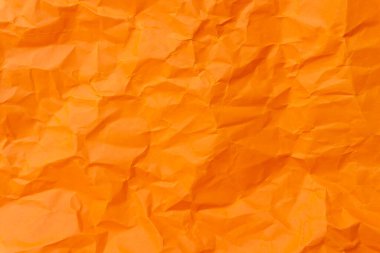 Üst görünüm ve buruşmuş veya buruşmuş turuncu kağıdın tam çerçevesi buruşuk turuncu kağıt arka plan dokusu olarak kullanılır. 