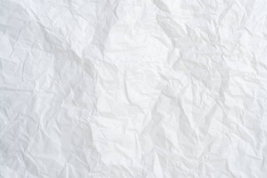 Üst görünüm ve buruşmuş beyaz kağıt dokusu dekoratif sanat eserlerinde buruşmuş beyaz kağıt arkaplan dokusu olarak kullanılır..