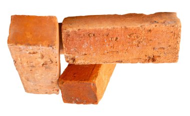 Yığındaki üç eski kırmızı veya turuncu tuğlanın yan görünümü kırpma yolu ile beyaz arkaplanda izole edilmiştir.