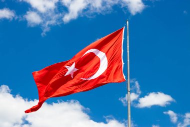 Waving Turkish flag. Sky background. Flag with star and crescent symbol. High quality photo