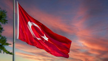 Günbatımı arkaplanlı Türk bayrağı. Ulusal tatil ve özgürlük günleri için arka plan resmi. Fotokopi bölgesi afişi, postası ya da hikayesi için uygun. Yüksek kalite fotoğraf