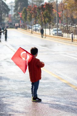 Cumhuriyet Günü kutlamalarında Türk bayrağını gururla taşıyan genç bir çocuk, ülkenin umudunu ve geleceğini simgeliyor. 29 Ekim 2023 - Erzurum, Türkiye .