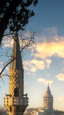 A serene view of a minaret and the iconic Galata Tower in Istanbul, Turkey, symbolizing a harmonious blend of Islamic heritage, Ramadan spirit, and urban history. clipart