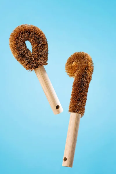 Eco natural bamboo household brushes over blue background. Zero waste kitchen cleaning concept. Plastic free.