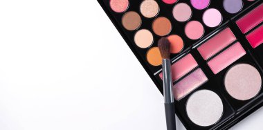 Multi colored eye shadow palette with brush top view. Abstract beauty background with eye shadows and blusher. 