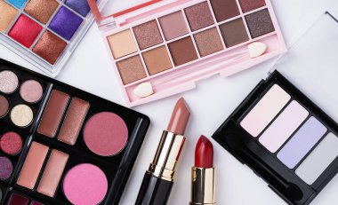 Eye shadow palettes and liptstick  on white background. Decorative cosmetics. Beauty products. 