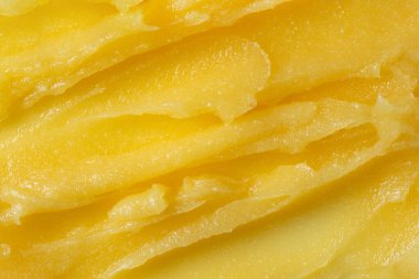 Soyut sarı şeker vücut temizleme dokusu. Mango ya da yüz bakımı için fırçala. Cilt bakımı vücut fırçalama arka planı.