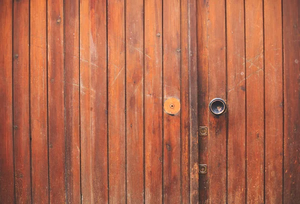 stock image old weathered wooden doors with a rusty metal handle